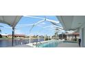 Screened-in pool overlooking a canal, providing a tranquil outdoor space at 494 Monaco Dr, Punta Gorda, FL 33950