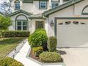 Inviting front entrance with a well-lit walkway and a neatly landscaped garden at 726 Connemara Ct, Venice, FL 34292