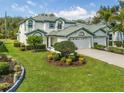 Landscaped front yard with a lush lawn, decorative shrubbery and trees enhancing curb appeal at 726 Connemara Ct, Venice, FL 34292