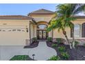 Inviting front entrance showcases a beautiful front door, well-maintained landscaping, and stone detailing at 1321 Eagles Flight Way, North Port, FL 34287
