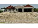 New construction home featuring concrete block walls, a two-car garage, and modern architectural design at 14735 Keystone Blvd, Port Charlotte, FL 33981