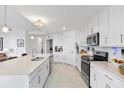 Bright, modern kitchen features stainless steel appliances and a large island at 15970 Grassland Ln # 2816, Punta Gorda, FL 33982