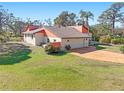 Spacious single-Gathering home on a large lot with an attached two-car garage and ample green space at 1701 Overbrook Rd, Englewood, FL 34223