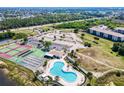 Aerial view showing the community pool, tennis courts, parking and the building location at 175 Kings Hwy # 232, Punta Gorda, FL 33983