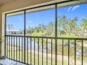 Enjoy serene water views from this condo balcony, surrounded by lush greenery at 25050 Sandhill Blvd # B2 Building 6, Punta Gorda, FL 33983