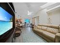 Open-concept living room featuring vaulted ceilings, recessed lighting, and wood-look floors leading to the kitchen at 25069 Bolivar Dr, Punta Gorda, FL 33983