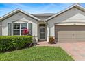 Charming single-story home with a well-manicured lawn, brick paver walkway and a two car garage at 3860 Cobblestone Ln, Punta Gorda, FL 33980