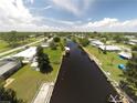 Aerial view of a canal community featuring waterfront homes, docks and lush greenery at 4045 Conway Blvd, Port Charlotte, FL 33952