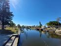 Scenic canal view with waterfront properties and private docks under a clear blue sky at 4045 Conway Blvd, Port Charlotte, FL 33952