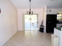 Bright dining area with sliding glass doors to porch and view into kitchen at 5098 Adina Cir, North Port, FL 34291