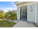The front entrance welcomes you with beautiful landscaping, wrought iron gate, and a charming blue accent wall at 5126 Richmond Ter, North Port, FL 34287