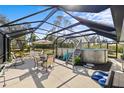Outdoor living space includes a screened-in patio with above ground pool, dining area, and lounge seating at 5126 Richmond Ter, North Port, FL 34287