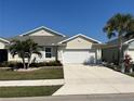 Charming single-story home featuring a two-car garage, manicured landscaping, and a well-maintained lawn at 7304 W Lenox Circle, Punta Gorda, FL 33950