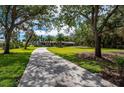 Lush front yard and winding driveway leading to a beautiful home at 75 Spyglass Aly, Placida, FL 33946
