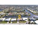 An aerial view of a waterfront community with canals and single-Gathering homes at 944 Genoa Ct, Punta Gorda, FL 33950