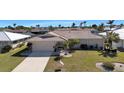 Charming single-story home featuring a well-manicured lawn and a spacious driveway at 944 Genoa Ct, Punta Gorda, FL 33950