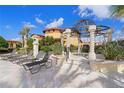 Relaxing poolside lounge area with luxury lounge chairs and sunshade structure at 99 Vivante Blvd # 404, Punta Gorda, FL 33950