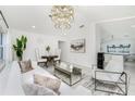 Bright living room with modern chandelier, stylish seating, and open floor plan at 14195 Brisk Ave, Port Charlotte, FL 33953