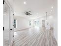 Bright and airy living room featuring neutral paint, light laminate flooring, and recessed lighting at 160 Green Pine Park, Rotonda West, FL 33947
