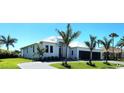 Beautiful contemporary home featuring a lush landscaped yard, circular driveway and three car garage at 1631 Casey Key Dr, Punta Gorda, FL 33950