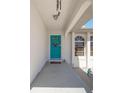 Welcoming front entrance with a turquoise door and a decorative wreath at 18662 Arapahoe Cir, Port Charlotte, FL 33948