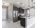 Modern kitchen features stainless steel appliances, sleek countertops, and pendant lighting at 24473 San Rafael Rd, Punta Gorda, FL 33955