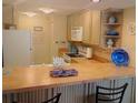 Efficient kitchen with a breakfast bar and functional appliances at 25188 Marion Ave # F303, Punta Gorda, FL 33950