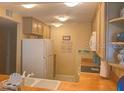 Cozy kitchen with neutral cabinetry, and efficient appliances at 25188 Marion Ave # F303, Punta Gorda, FL 33950
