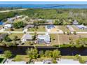 Aerial view showcases this home's fenced backyard oasis with a pool and proximity to a canal at 3024 Caribbean Dr, Punta Gorda, FL 33950