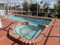 Inviting pool and spa combination with screened enclosure at 3024 Caribbean Dr, Punta Gorda, FL 33950