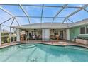 Inviting screened-in pool with spacious deck area and multiple seating areas for entertaining at 321 Pessoa St, Punta Gorda, FL 33983