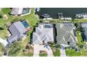 Aerial view of a property with a private pool, boat dock, and beautifully landscaped yard at 3906 Crooked Island Dr, Punta Gorda, FL 33950