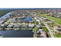 An aerial view of the community showing waterfront property with boat docks and manicured lawns at 3906 Crooked Island Dr, Punta Gorda, FL 33950