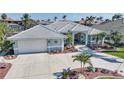 Charming single-Gathering home featuring a neutral color scheme, a spacious driveway, and lush landscaping at 3906 Crooked Island Dr, Punta Gorda, FL 33950