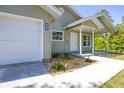 A close up of the charming one-story home with front porch and one car garage at 11401 2Nd Ave, Punta Gorda, FL 33955