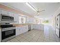 Bright, spacious kitchen featuring stainless steel appliances, granite countertops and tile flooring at 1214 Ansin St, Punta Gorda, FL 33950