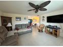 Open living room with tile flooring, ceiling fan, and a view of the dining area at 137 Revere Nw St, Port Charlotte, FL 33952