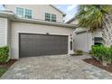 Attached garage with brick paved driveway and well manicured shrubs alongside property at 14049 Black Beauty Dr # 721, Punta Gorda, FL 33955