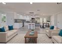 Open-concept living space featuring a modern kitchen, dining area, and comfortable seating at 165 Cummins Ne Ave, Port Charlotte, FL 33952