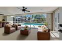 Enclosed patio featuring wicker furniture and views of the screened-in pool at 165 Cummins Ne Ave, Port Charlotte, FL 33952