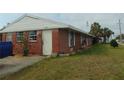 Charming brick home with white trim, a well-kept lawn, and inviting curb appeal at 20341 Midway Blvd, Port Charlotte, FL 33952