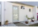 Inviting front entrance featuring a stylish light fixture and well-tended plants at 22375 Edgewater Dr # 149, Punta Gorda, FL 33980