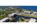 Beautiful aerial view of waterfront condos with boat docks, tennis courts and bay views at 25188 Marion Ave # D303, Punta Gorda, FL 33950