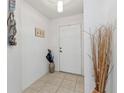 Apartment entryway features neutral decor, tile flooring, and a white door at 3322 Purple Martin Dr # 127, Punta Gorda, FL 33950