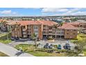 Condominium building with a tile roof and multiple levels in a neighborhood at 3322 Purple Martin Dr # 127, Punta Gorda, FL 33950