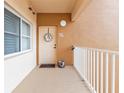 Apartment 127 door with a decorative wreath on the porch at 3322 Purple Martin Dr # 127, Punta Gorda, FL 33950