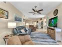 Comfortable living room features stylish furnishings and decor; view of study at 3393 Grand Vista Ct # 101, Port Charlotte, FL 33953