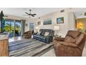 Comfortable living room with view of the outdoor patio through sliding glass doors at 3393 Grand Vista Ct # 101, Port Charlotte, FL 33953
