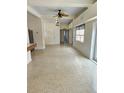 Spacious open living room with terrazzo floors, ceiling fans, and natural lighting at 4222 Gardner Dr, Port Charlotte, FL 33952