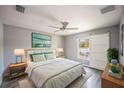 Bedroom featuring gray walls, wood-look floors, and a sliding barn door to the backyard at 4373 Atwater Dr, North Port, FL 34288